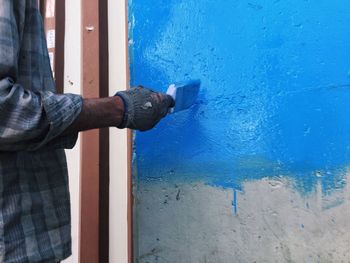 Close-up of hand on blue door