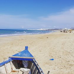 Scenic view of beach against blue sky