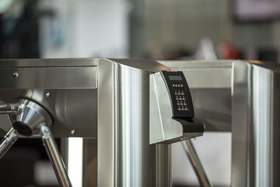 Close-up of electronic equipment on metallic railing