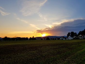 Scenic view of field against sky during sunset