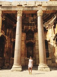 Rear view of woman standing in front of building