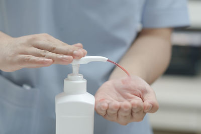 Close-up of hand holding bottle