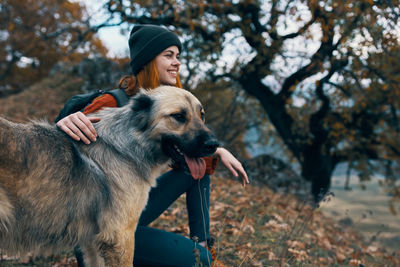 Full length of young woman with dog