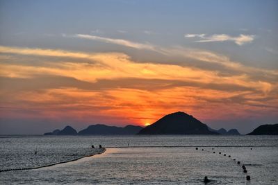 Scenic view of sea against orange sky