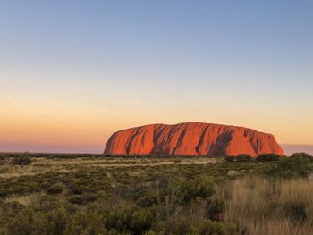 Scenic view of rock formation against sky during sunset