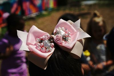 Close-up of tied bow with decoration on woman head