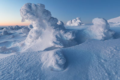 Scenic view of snowcapped landscape against sky