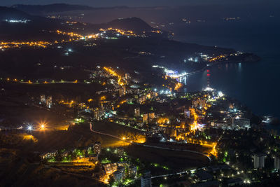 High angle view of illuminated city buildings at night