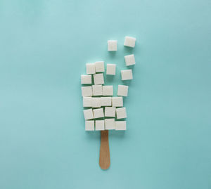 Refined sugar cubes on an ice cream stick, sugar in ice cream