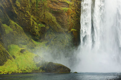 Scenic view of waterfall in sea