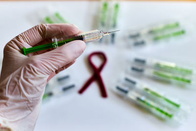 Cropped hand of doctor holding syringe