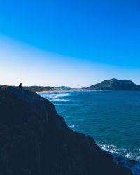 Scenic view of sea against clear blue sky