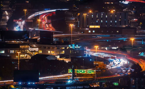 High angle view of illuminated city street and buildings at night