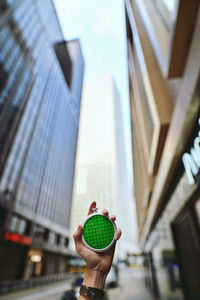Low angle view of person against building