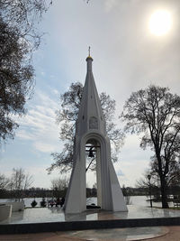 Low angle view of cross tower against sky