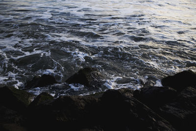 High angle view of rocks in sea