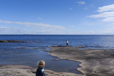 People on beach against sky