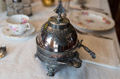 High angle view of antique teapot on dining table