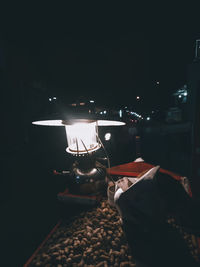 Man on illuminated table at night