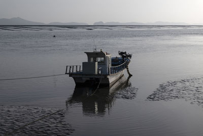 Boat sailing in sea against sky