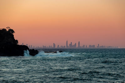 Scenic view of sea against orange sky