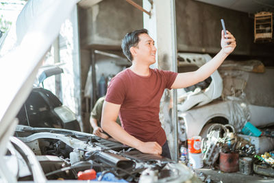 Portrait of young man using mobile phone