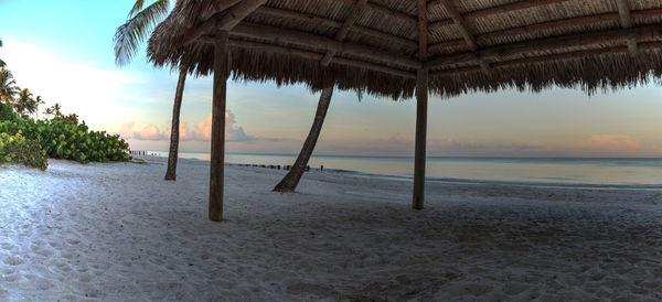 Scenic view of beach against sky during sunset