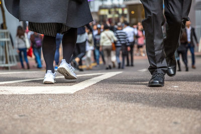 Low section of people walking on road