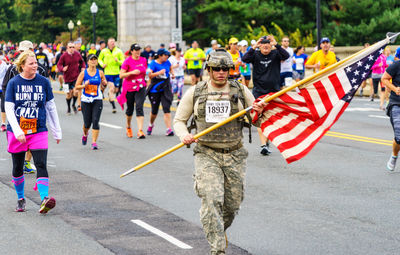 People standing in front of flags