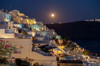 High angle view of illuminated buildings against sky at night