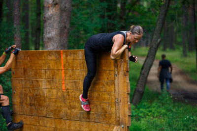 People on rock in forest