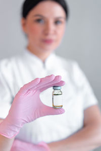 Midsection of doctor holding dental equipment