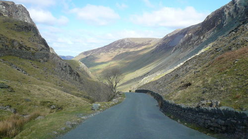 Narrow road along countryside landscape