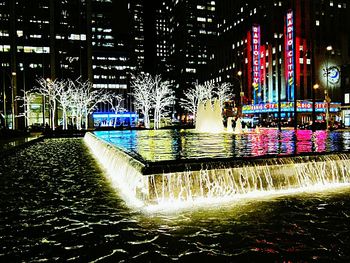 Illuminated buildings in city at night