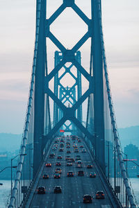 High angle view of suspension bridge over river against sky