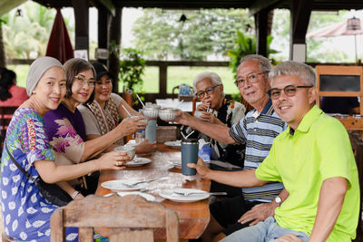 Portrait of smiling friends having food at restaurant