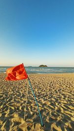 Scenic view of beach against clear blue sky