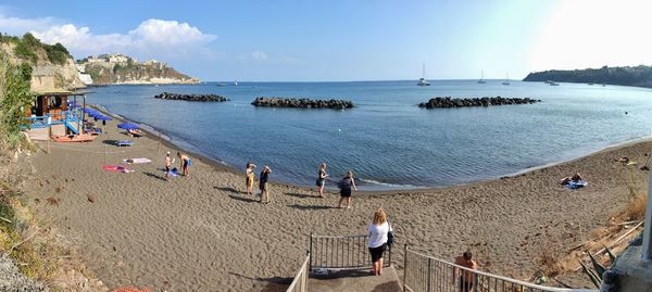 People on beach against sky