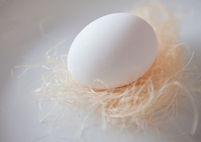 Close-up of easter egg over strings on table