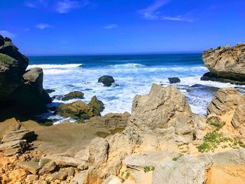 Scenic view of sea against blue sky