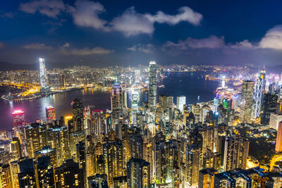 Illuminated cityscape against sky at night