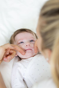 Mother with baby on bed at home