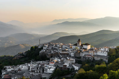 High angle view of townscape and mountains against sky