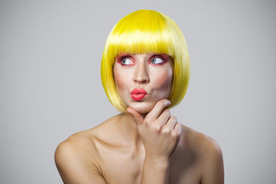 Portrait of beautiful young woman over white background