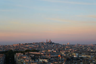 Aerial view of buildings against sky during sunset