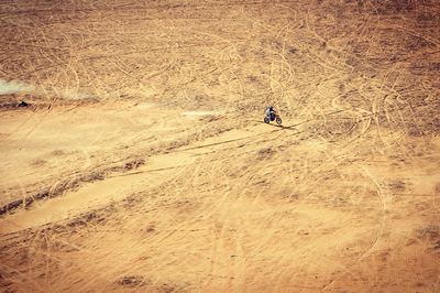 High angle view of person riding dirt bike on field