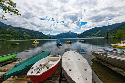 Boats moored in lake against sky