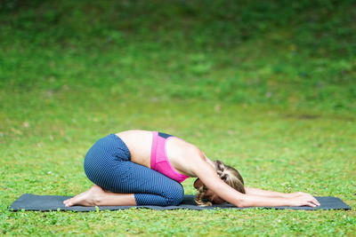 Woman lying on grass