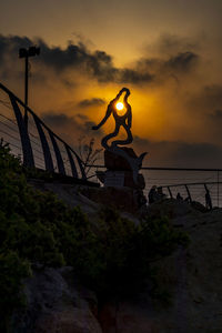 Low angle view of statue against sky during sunset