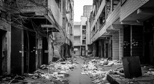 Footpath amidst destroyed buildings in city